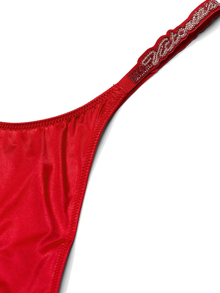 Tanga s sjajnim Script Shine naramenicama. Proizvod je crvene boje i dolazi iz kolekcije Very Sexy.