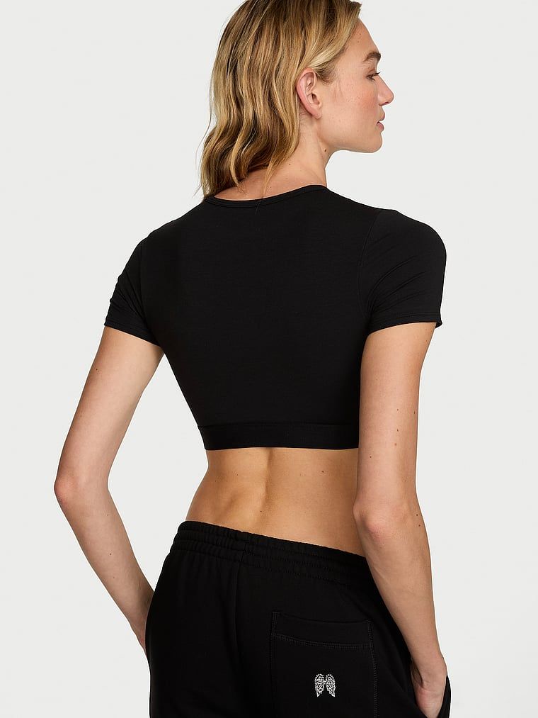 Crop top pamučni bralet s kratkim rukavima Shine Patch. Proizvod je crne boje i dolazi iz kolekcije majica.