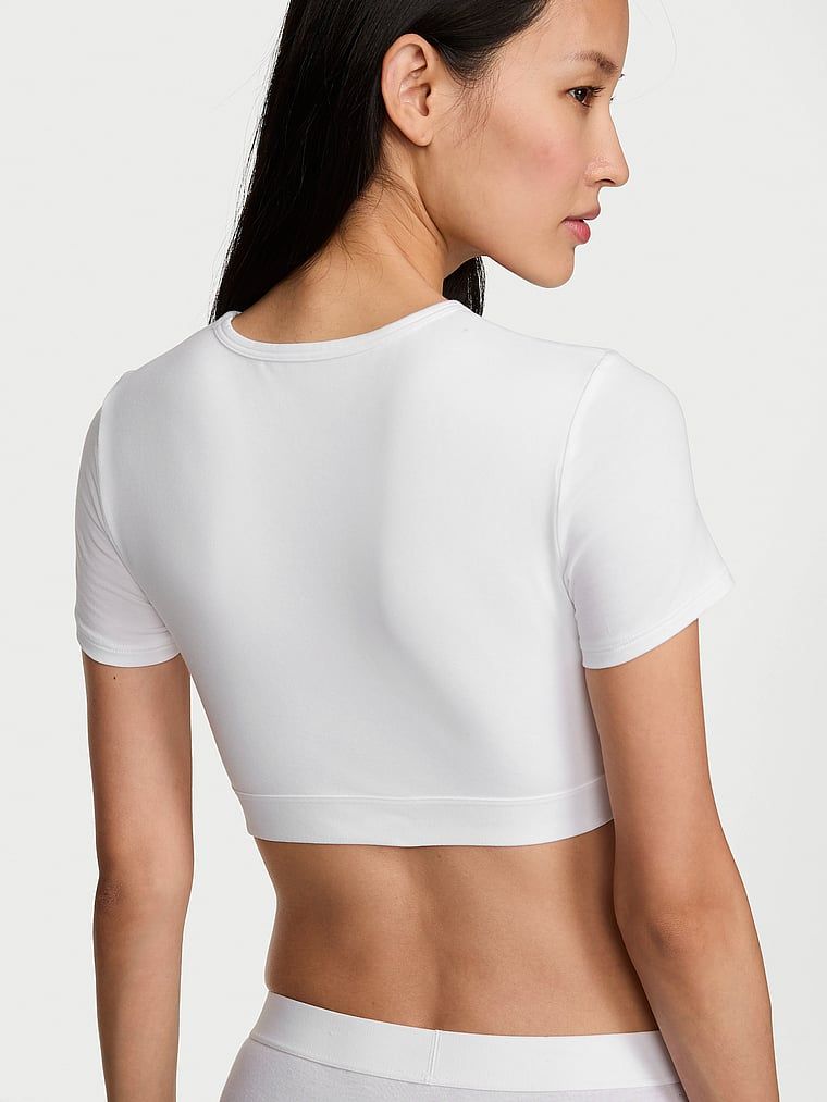 Crop top pamučni bralette s kratkim rukavima Shine Patch. Proizvod je bijele boje i dolazi iz kolekcije majica.